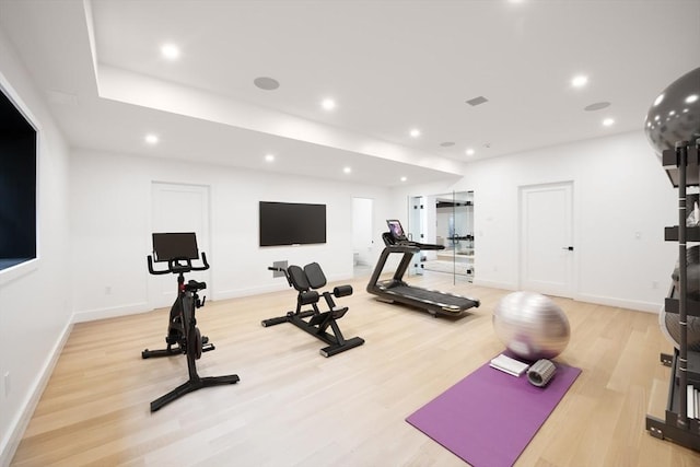 workout room featuring light wood-type flooring