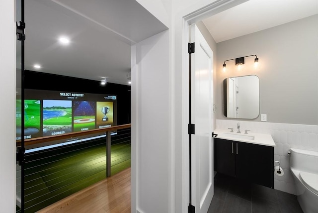 bathroom with vanity, wood-type flooring, tile walls, and toilet