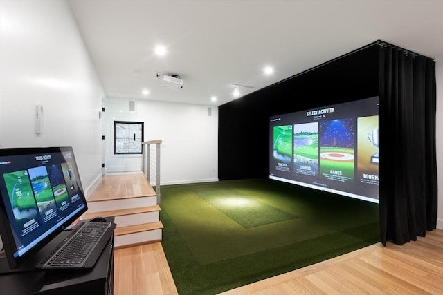 playroom featuring golf simulator and wood-type flooring