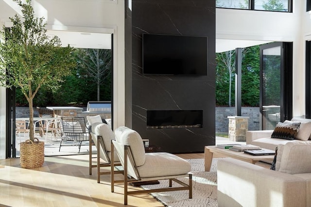 living room with a fireplace and light wood-type flooring