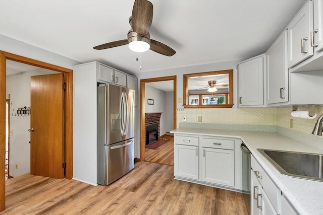 21 Gile St, Haverhill, MA 01830 - kitchen with stainless steel appliances, a ceiling fan, a sink, tasteful backsplash, and light countertops