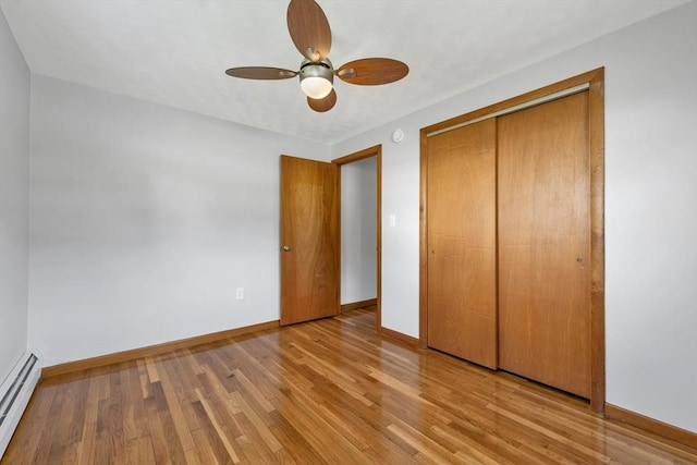 21 Gile St, Haverhill, MA 01830 - unfurnished bedroom with a baseboard radiator, baseboards, wood finished floors, and a closet