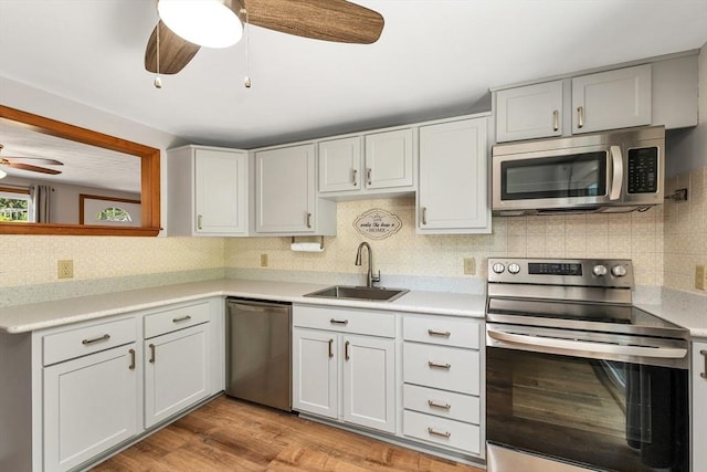 21 Gile St, Haverhill, MA 01830 - kitchen with stainless steel appliances, ceiling fan, a sink, and backsplash