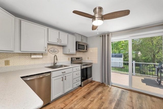 21 Gile St, Haverhill, MA 01830 - kitchen with stainless steel appliances, a sink, light countertops, and light wood-style flooring