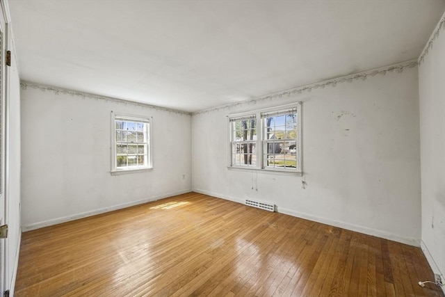 empty room featuring hardwood / wood-style floors and baseboards