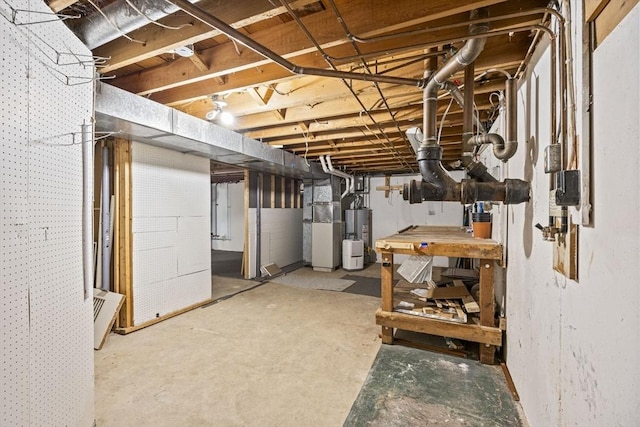 unfinished basement with gas water heater and heating unit