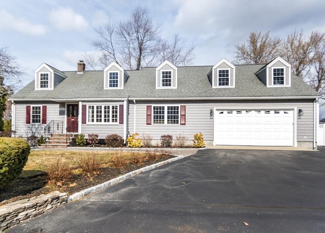 cape cod home featuring a chimney, driveway, a shingled roof, and a garage