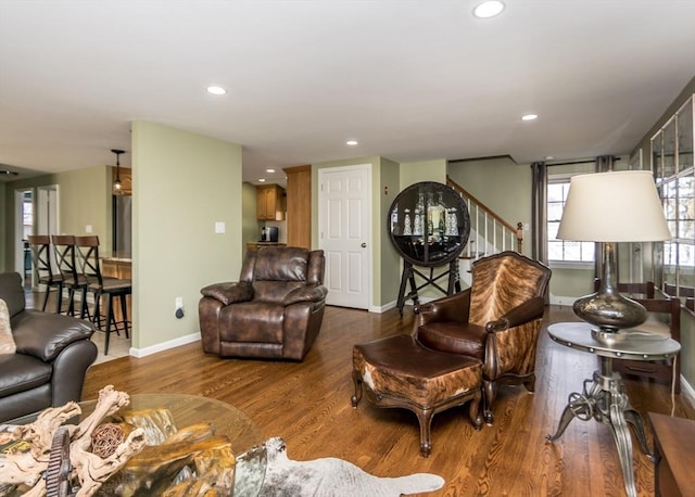 living room featuring stairway, recessed lighting, baseboards, and wood finished floors