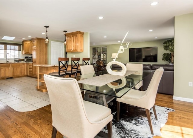 dining space with recessed lighting, baseboards, and light wood-style flooring