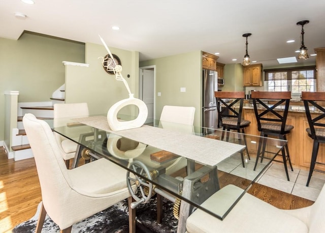 dining room with recessed lighting, stairway, and light wood-style floors