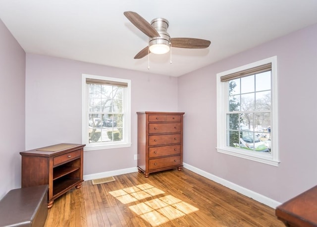 bedroom featuring visible vents, a ceiling fan, light wood-type flooring, and baseboards