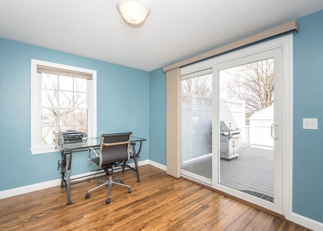 office area with baseboards and hardwood / wood-style flooring