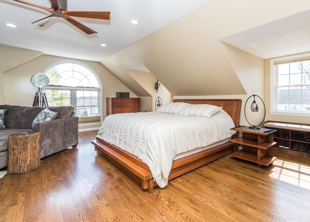 bedroom with lofted ceiling, multiple windows, wood finished floors, and recessed lighting