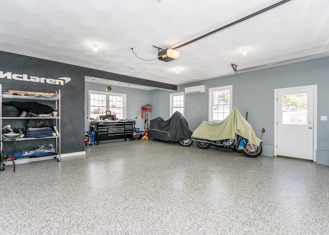 garage with a garage door opener and a wall mounted AC