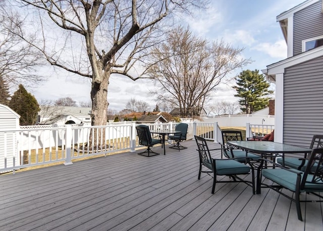 wooden terrace featuring outdoor dining space and fence