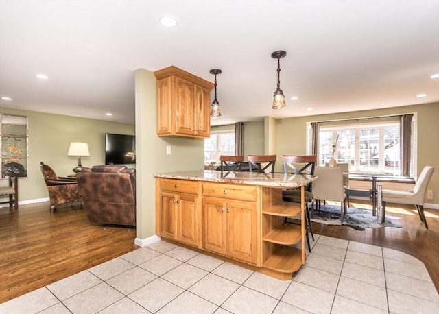 kitchen featuring decorative light fixtures, recessed lighting, a peninsula, and light wood-type flooring