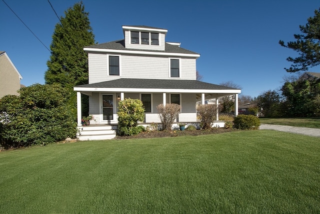 view of front of house featuring covered porch and a front yard