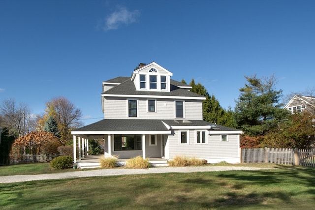 view of front of property with covered porch and a front yard