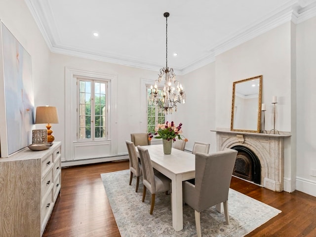 dining area featuring a chandelier, ornamental molding, dark hardwood / wood-style flooring, and a baseboard heating unit