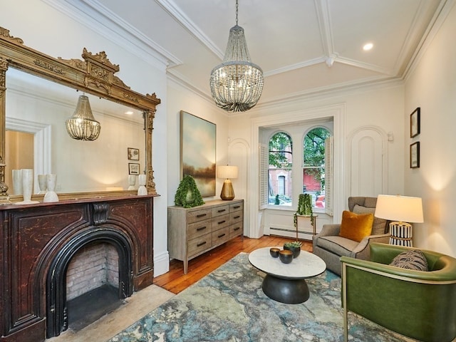 living area with an inviting chandelier, crown molding, vaulted ceiling, a baseboard radiator, and light hardwood / wood-style floors