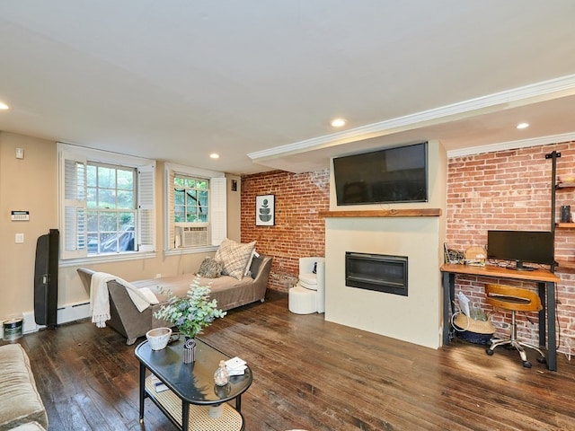 living room featuring a large fireplace, dark wood-type flooring, brick wall, a baseboard heating unit, and cooling unit