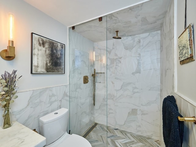 bathroom with a tile shower, tile walls, and toilet