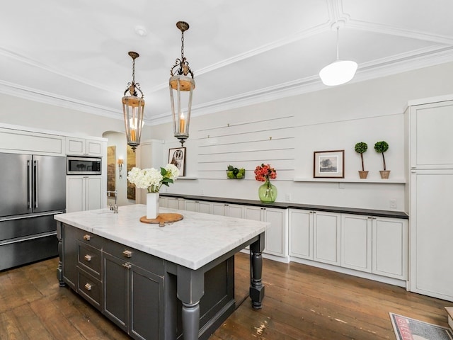 kitchen with a center island, dark hardwood / wood-style flooring, hanging light fixtures, and appliances with stainless steel finishes