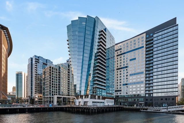 exterior space with a water view and a city view