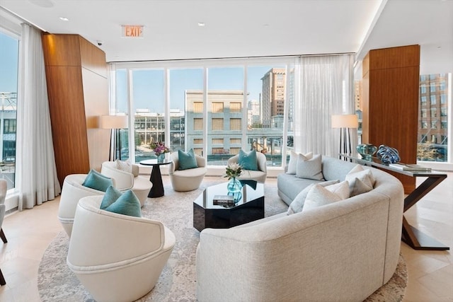 living room featuring a wall of windows and a city view