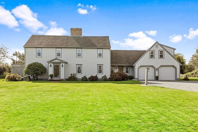 colonial inspired home featuring a front yard, driveway, central AC, and a chimney