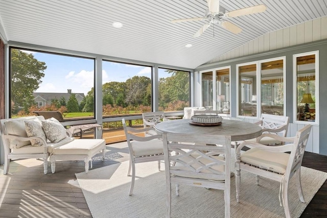 sunroom featuring vaulted ceiling, a ceiling fan, and wooden ceiling