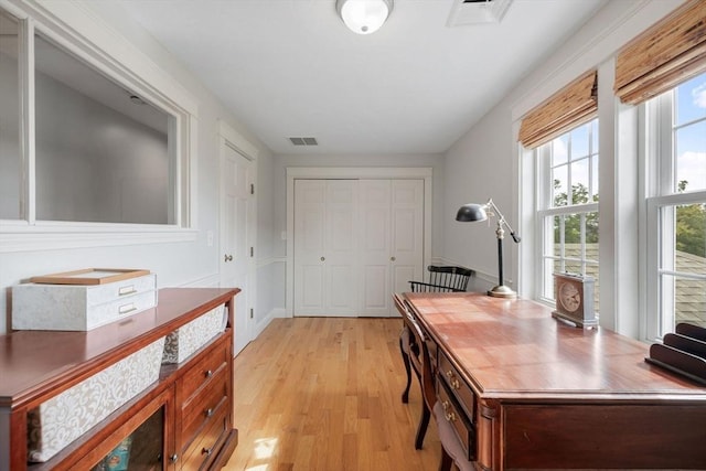 home office featuring light wood-style flooring and visible vents