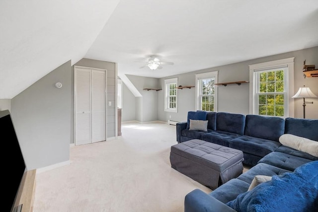 living room featuring a healthy amount of sunlight, baseboards, ceiling fan, and carpet floors