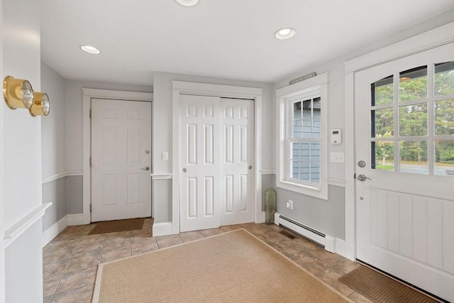 entrance foyer with recessed lighting, a baseboard heating unit, and baseboards