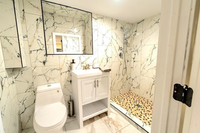 bathroom with vanity, toilet, marble finish floor, and a marble finish shower