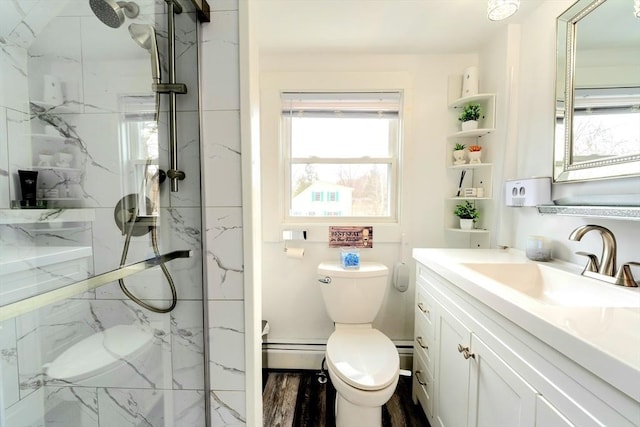 full bath with a marble finish shower, toilet, a baseboard heating unit, and vanity