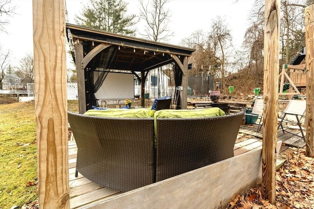 view of patio featuring a gazebo, a trampoline, and fence