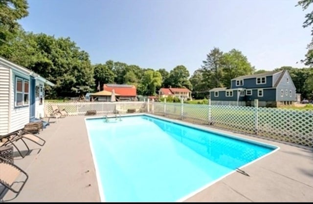 view of swimming pool featuring a fenced in pool, a patio area, and fence