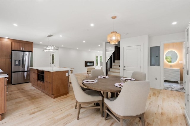 174 Gilbert St, Mansfield, MA 02048 - dining room with electric panel, stairs, light wood-style floors, and recessed lighting