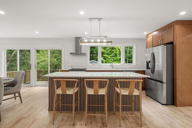 174 Gilbert St, Mansfield, MA 02048 - kitchen with stainless steel refrigerator with ice dispenser, wall chimney range hood, light countertops, a center island, and recessed lighting