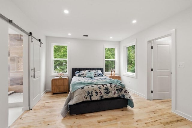 174 Gilbert St, Mansfield, MA 02048 - bedroom featuring a barn door, light wood finished floors, and recessed lighting