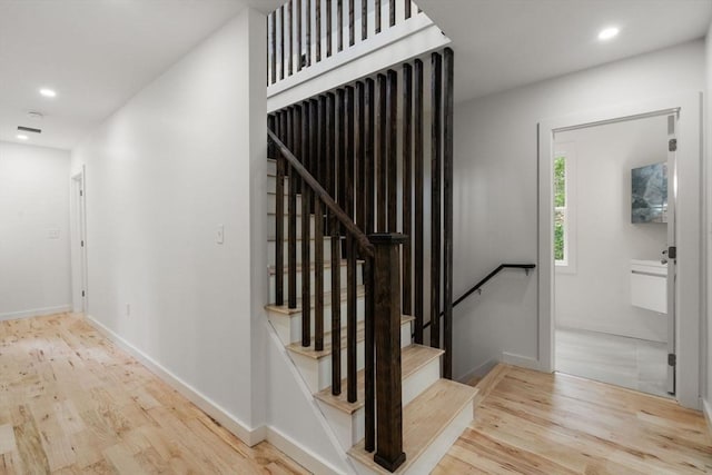 174 Gilbert St, Mansfield, MA 02048 - staircase with wood finished floors and recessed lighting