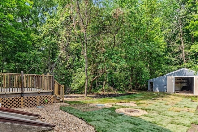 174 Gilbert St, Mansfield, MA 02048 - view of grassy yard with an outbuilding, a wooden deck, an outdoor structure, and a wooded view