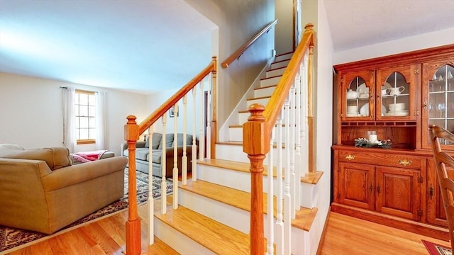 stairs featuring hardwood / wood-style floors