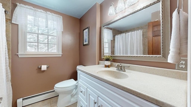 bathroom with vanity, toilet, a baseboard heating unit, and tile patterned flooring