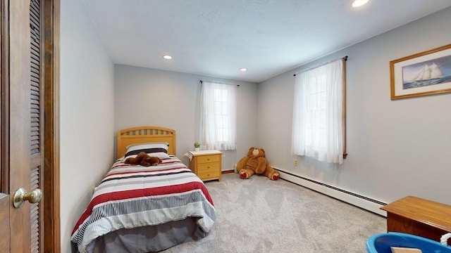 carpeted bedroom featuring a baseboard heating unit