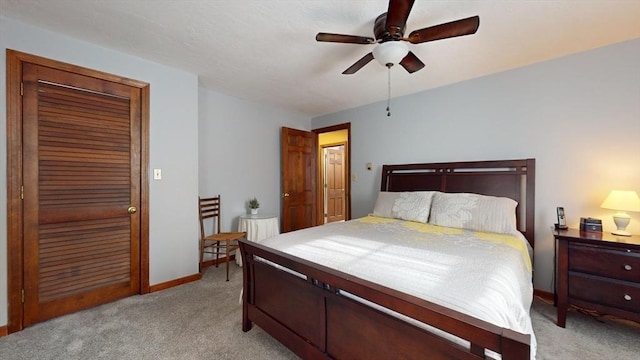 bedroom with light colored carpet, a closet, and ceiling fan