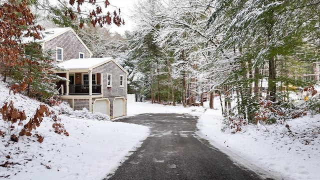 view of snow covered exterior with a garage