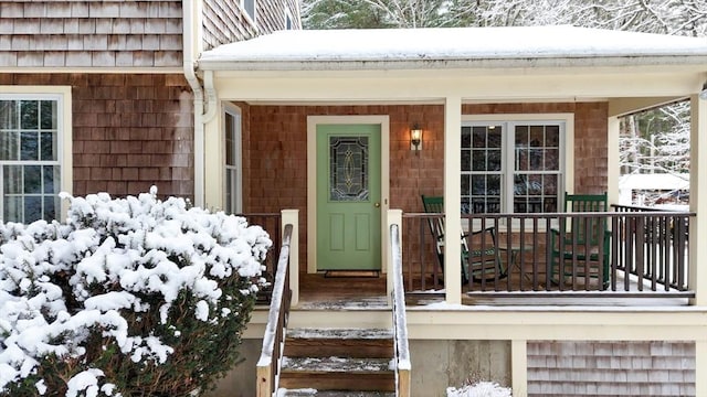 view of snow covered property entrance