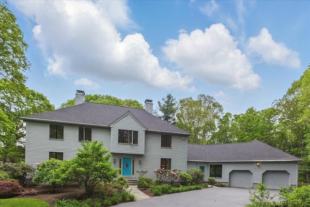 183 Kings Grant Rd, Weston, MA 02493 - view of front facade featuring a chimney, asphalt driveway, a garage, and a shingled roof